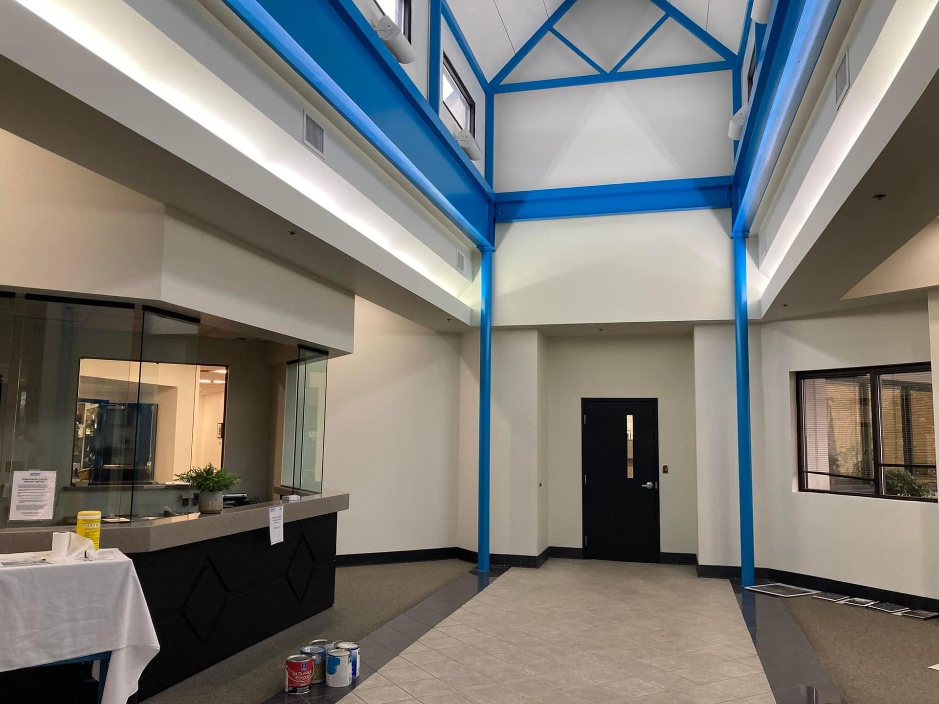 A large room with a blue ceiling and white walls