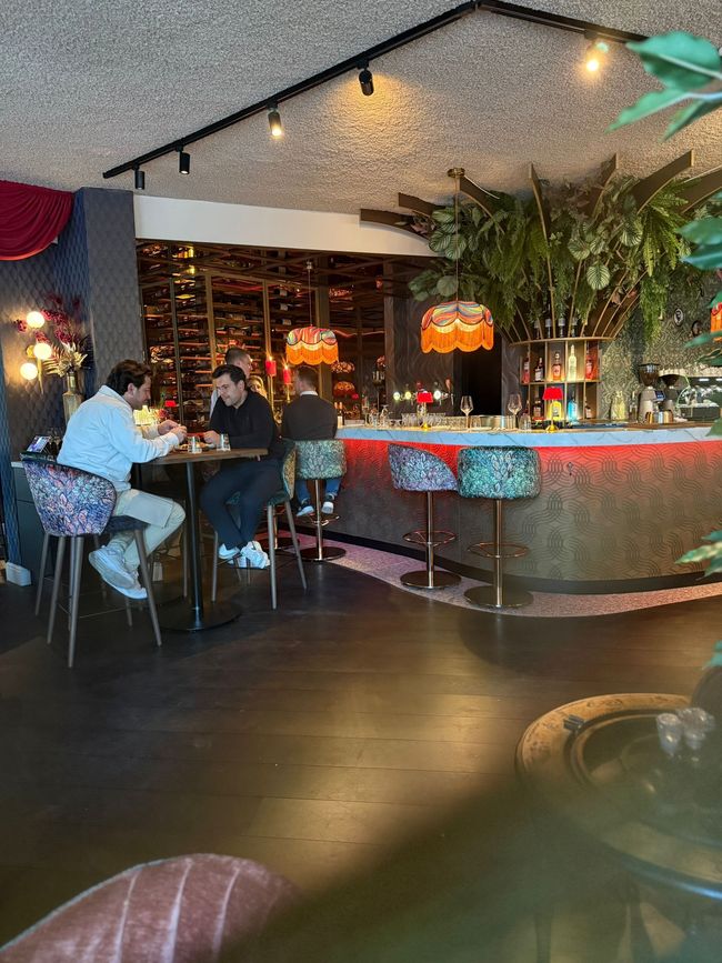 De chef-kok garneert het gerecht met paddenstoelen met een lepel op een houten schaal, omgeven door rook van droogijs.