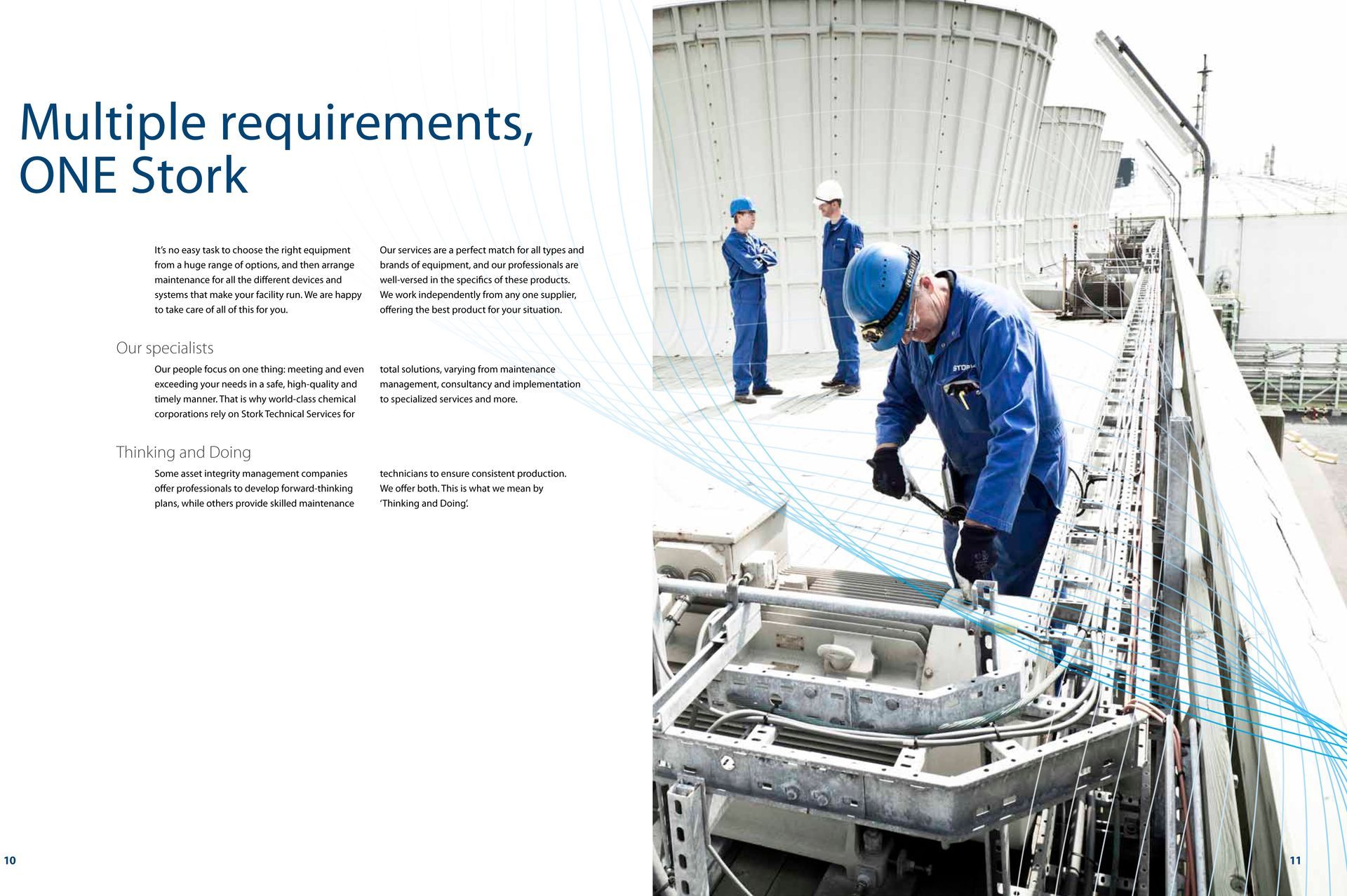 A man in a blue uniform is working on a machine in a factory.