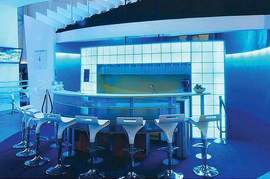 A blue room with a bar and stools
