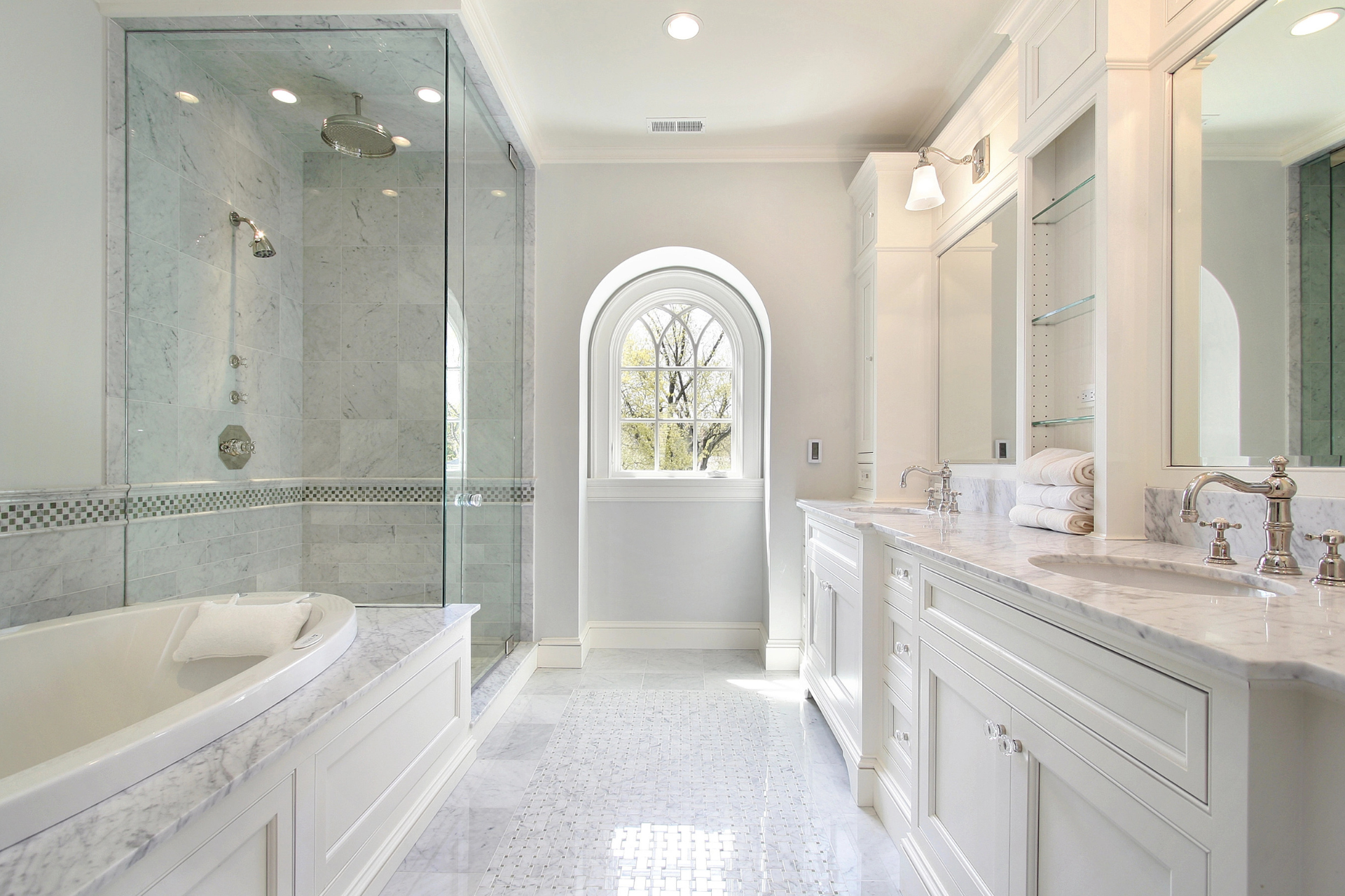 A spacious master bathroom featuring a large tub and a separate shower area.