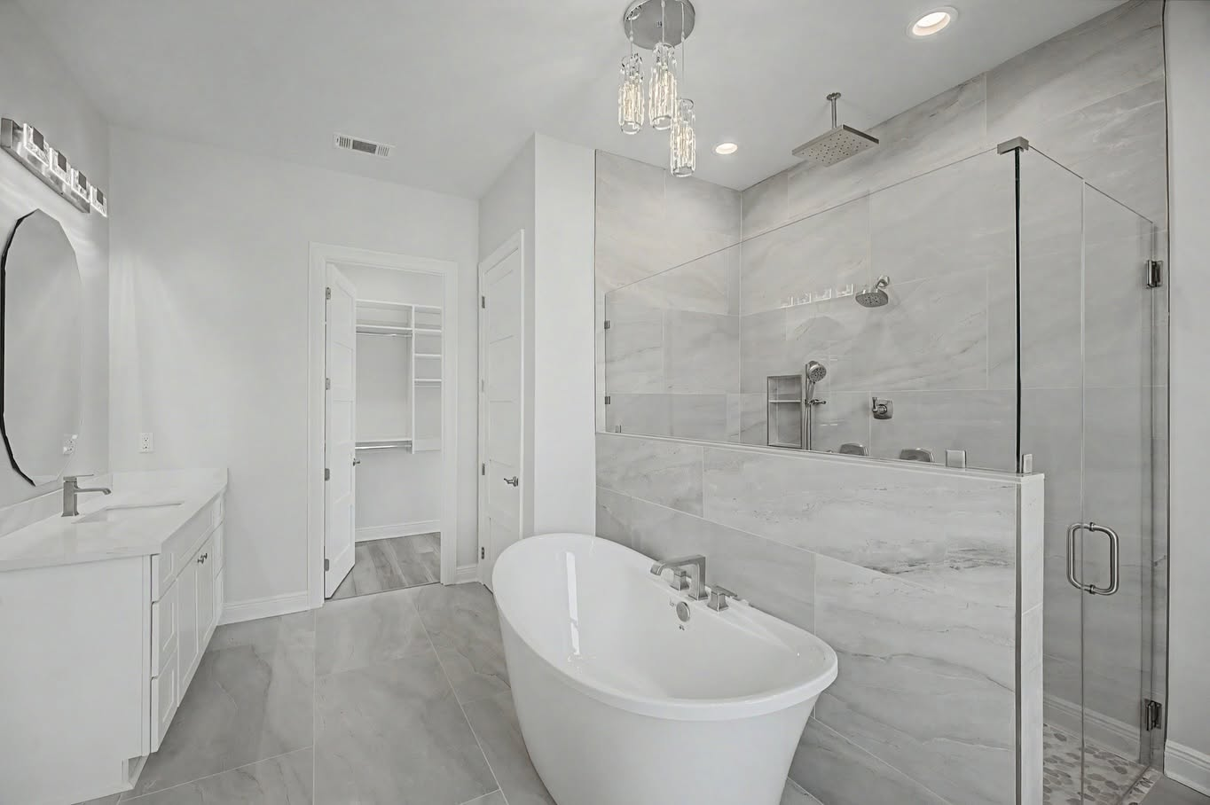 Custom primary bathroom with a freestanding tub and large glass-enclosed tile shower