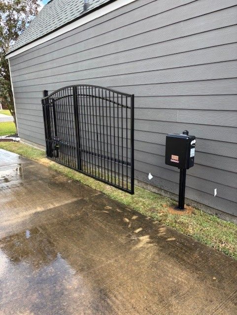 Black wrought iron fence with decorative panels and pointed tops.