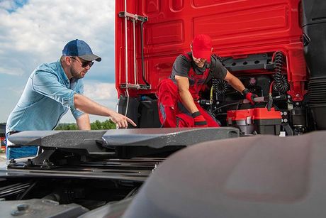 Trucker Showing Mechanic a Problem with His Truck
