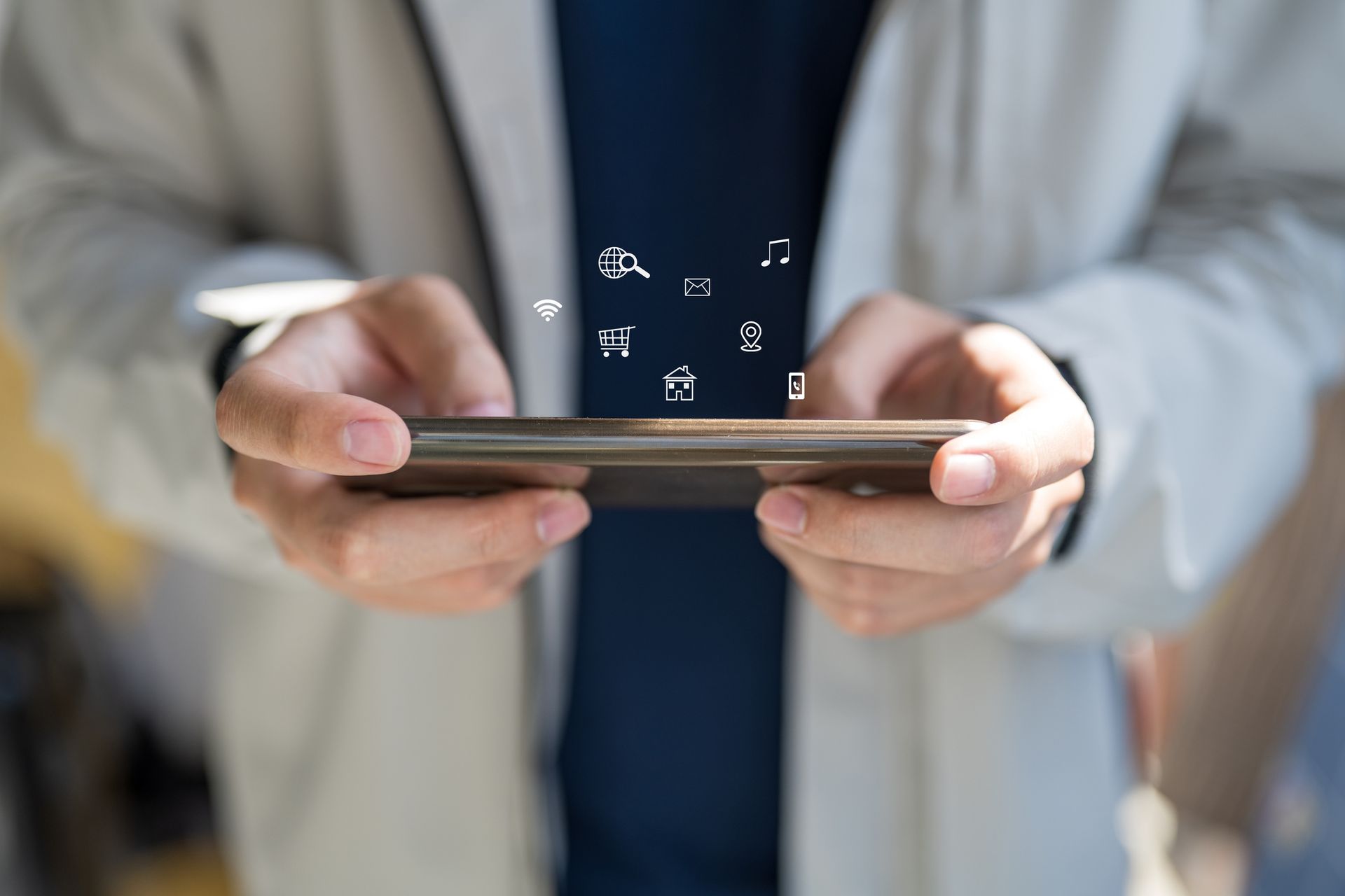 A man is holding a cell phone in his hands.