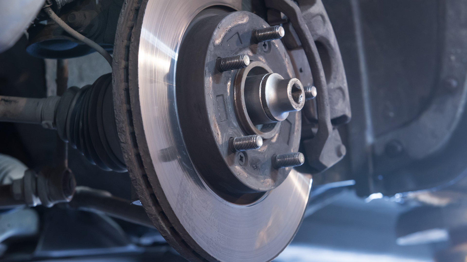 A close up of a brake disc on a car.