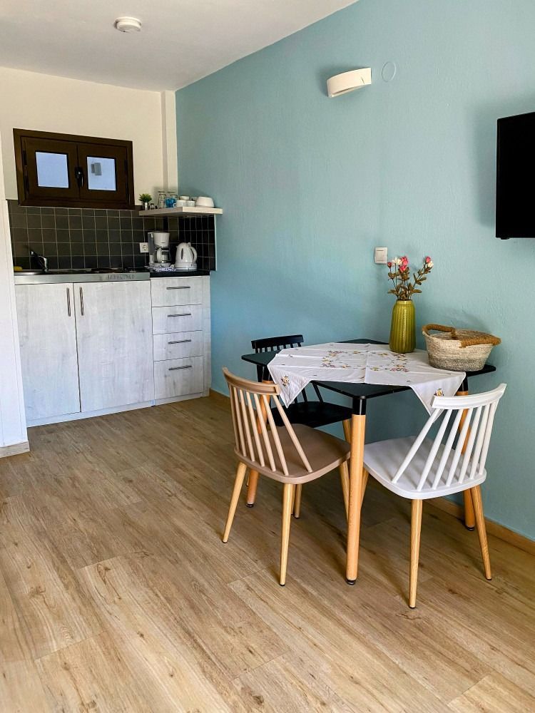 There is a table and chairs in the middle of the room.