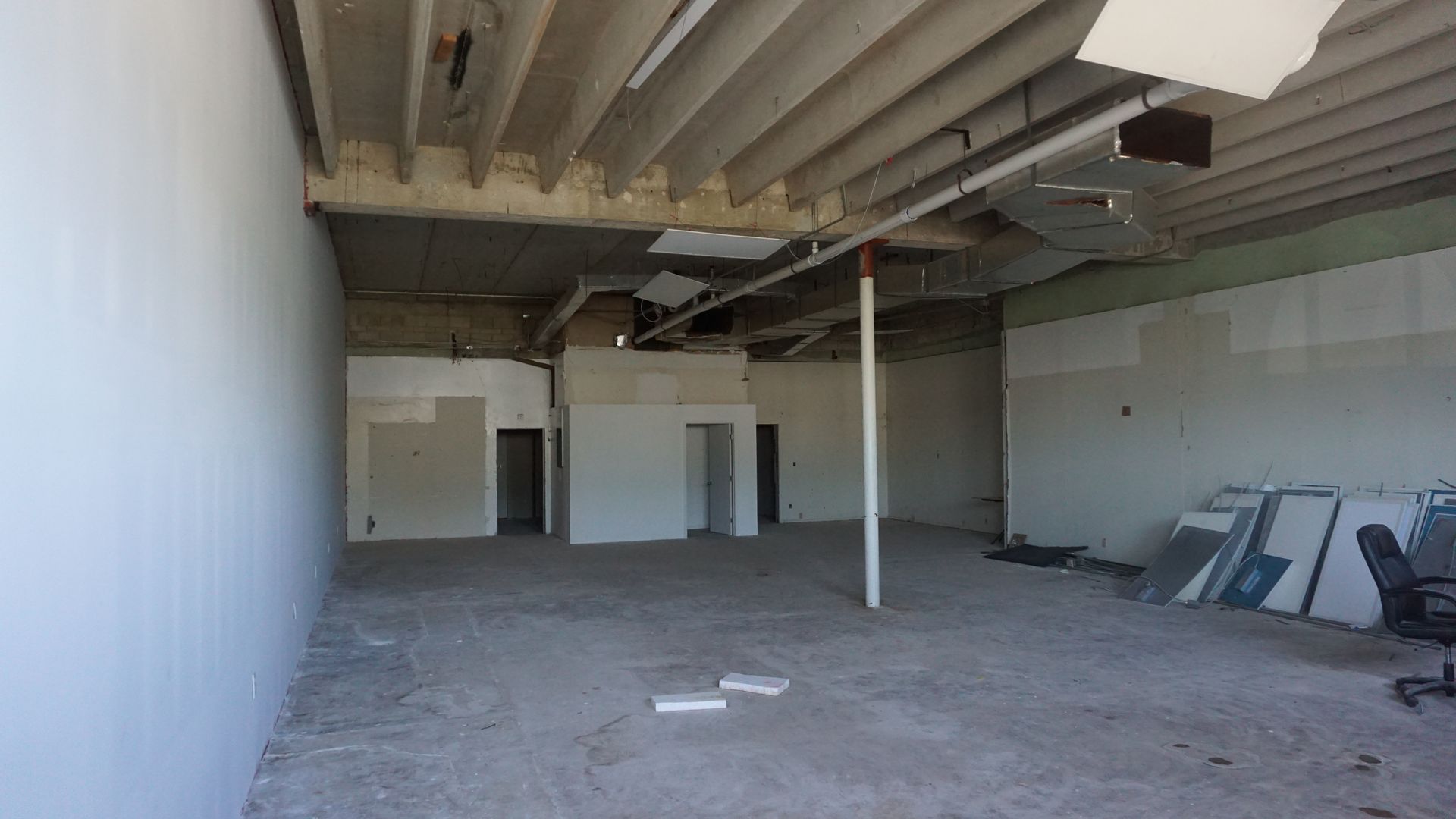 A large empty room with a ceiling that is missing