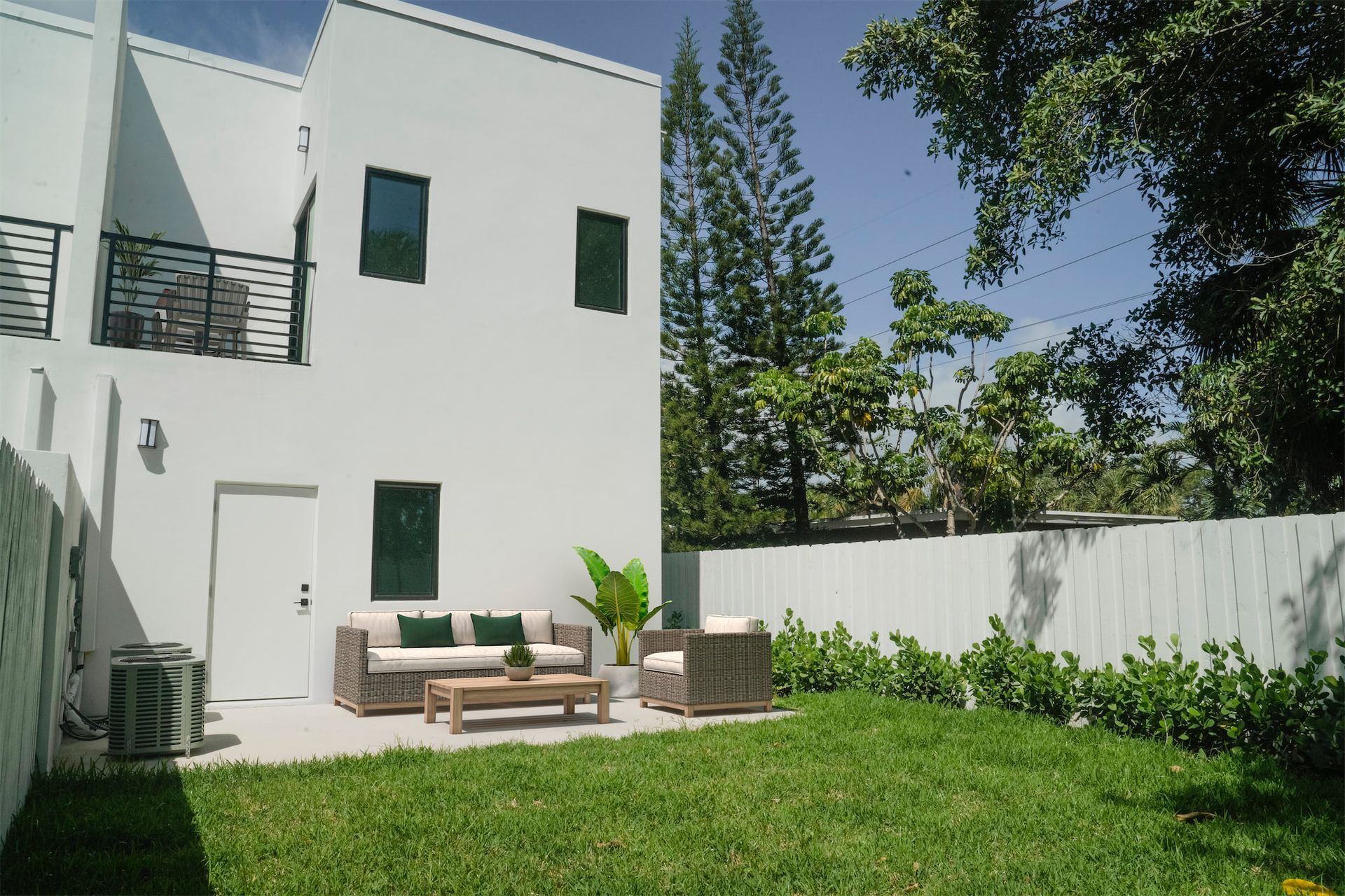 a white house with a patio area in front of it