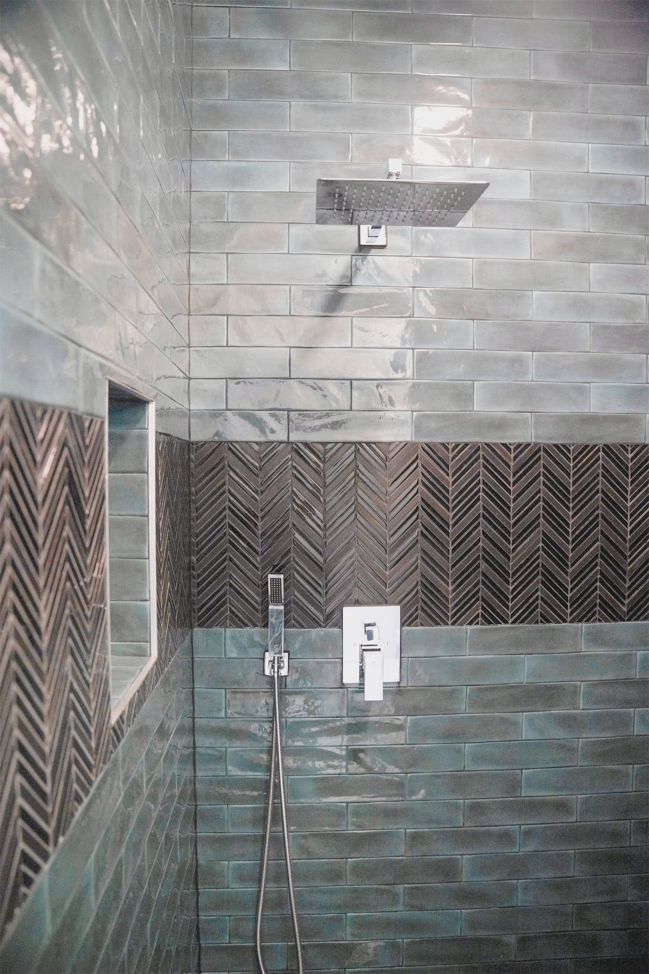 a bathroom with a walk in shower and a shower head .