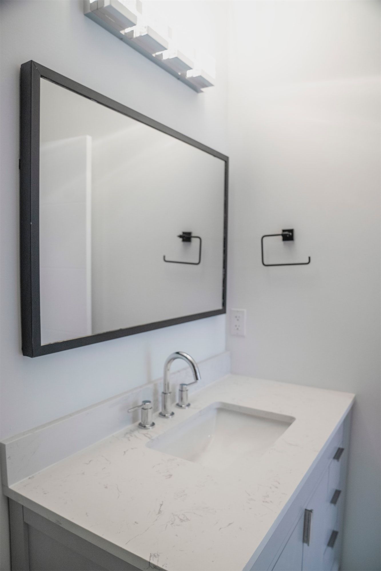 a bathroom sink with a large mirror above it .