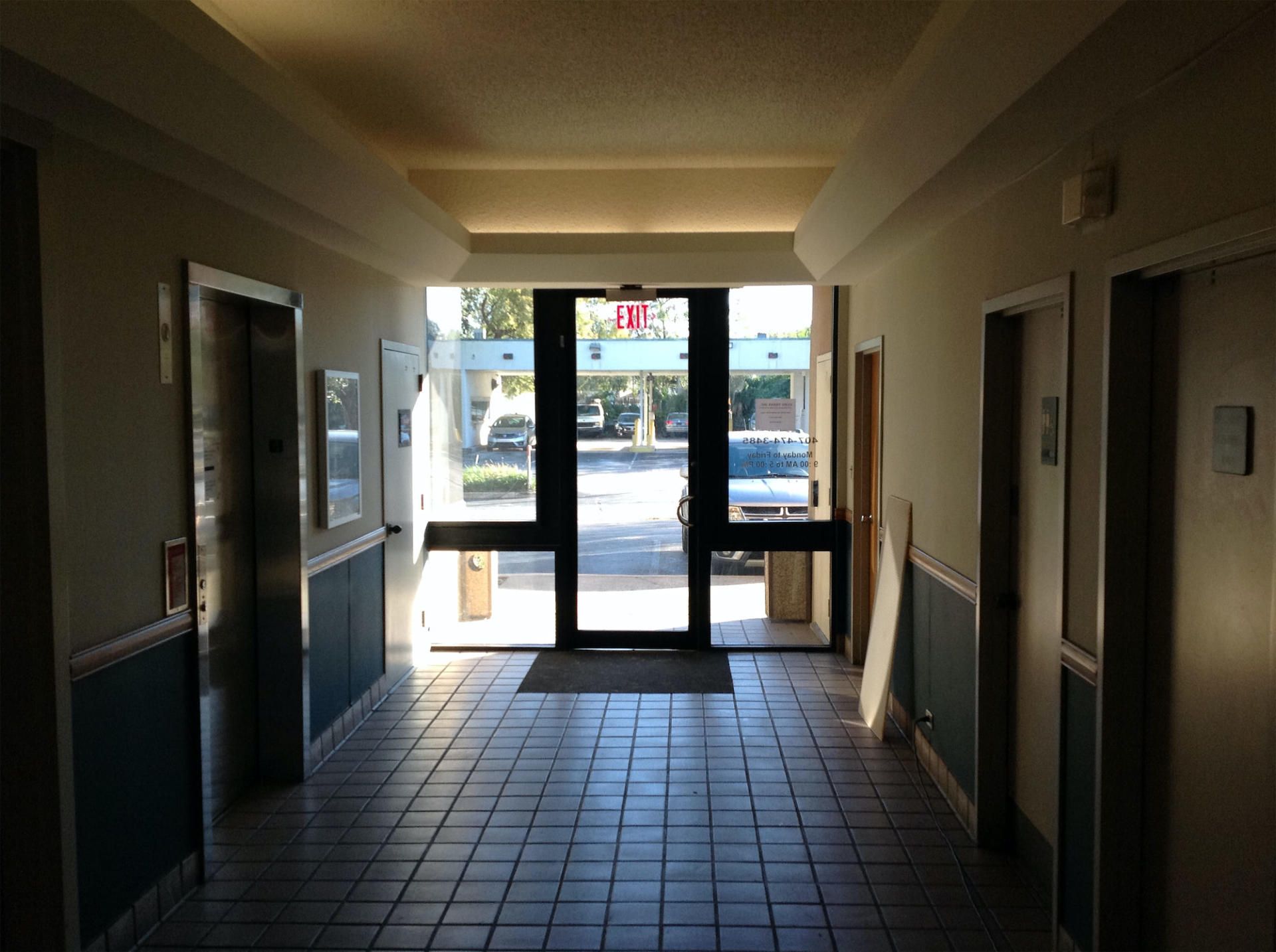 a hallway with a exit sign on the door