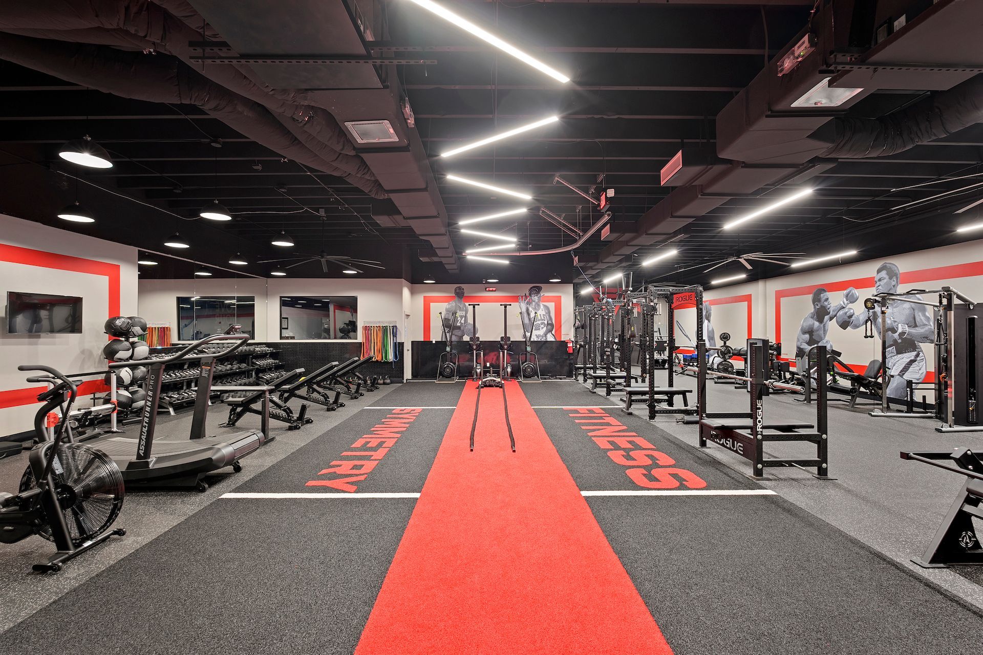 There is a red carpet in the middle of the gym.