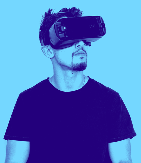 a man wearing a virtual reality headset on a blue background .