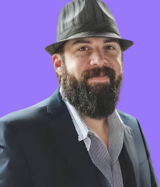 A woman in a black jacket and white top is smiling against a purple background.