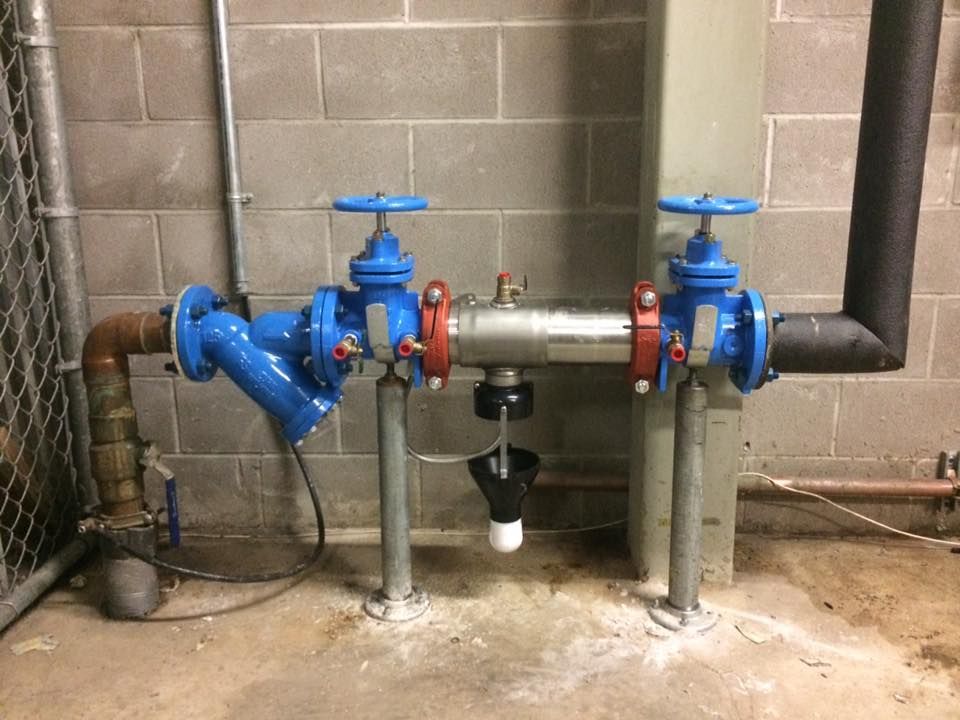 A bunch of pipes are connected to each other in a room.