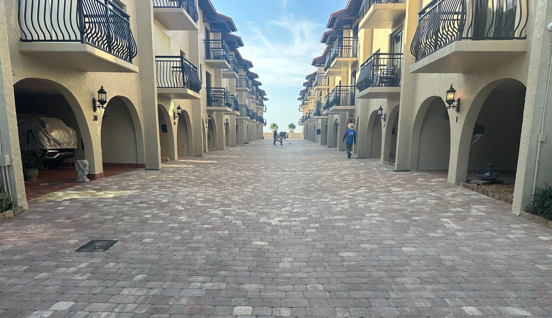 A row of buildings with a brick driveway between them