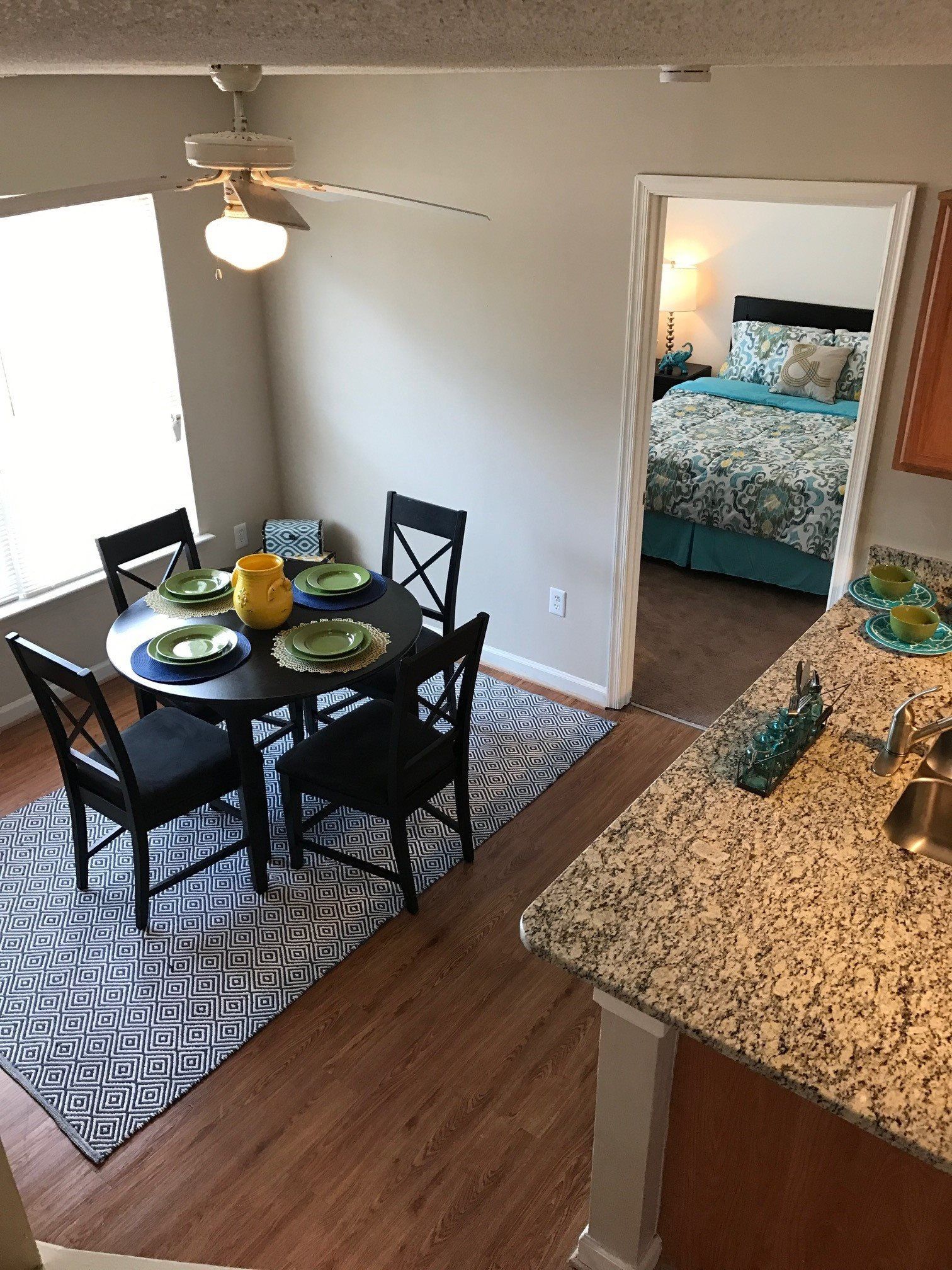 Dining Room/Kitchen/View of Bedroom at Suites at Port Warwick