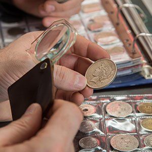 Numismatist Inspecting Coin - Coin Appraisals in Derry, New Hampshire