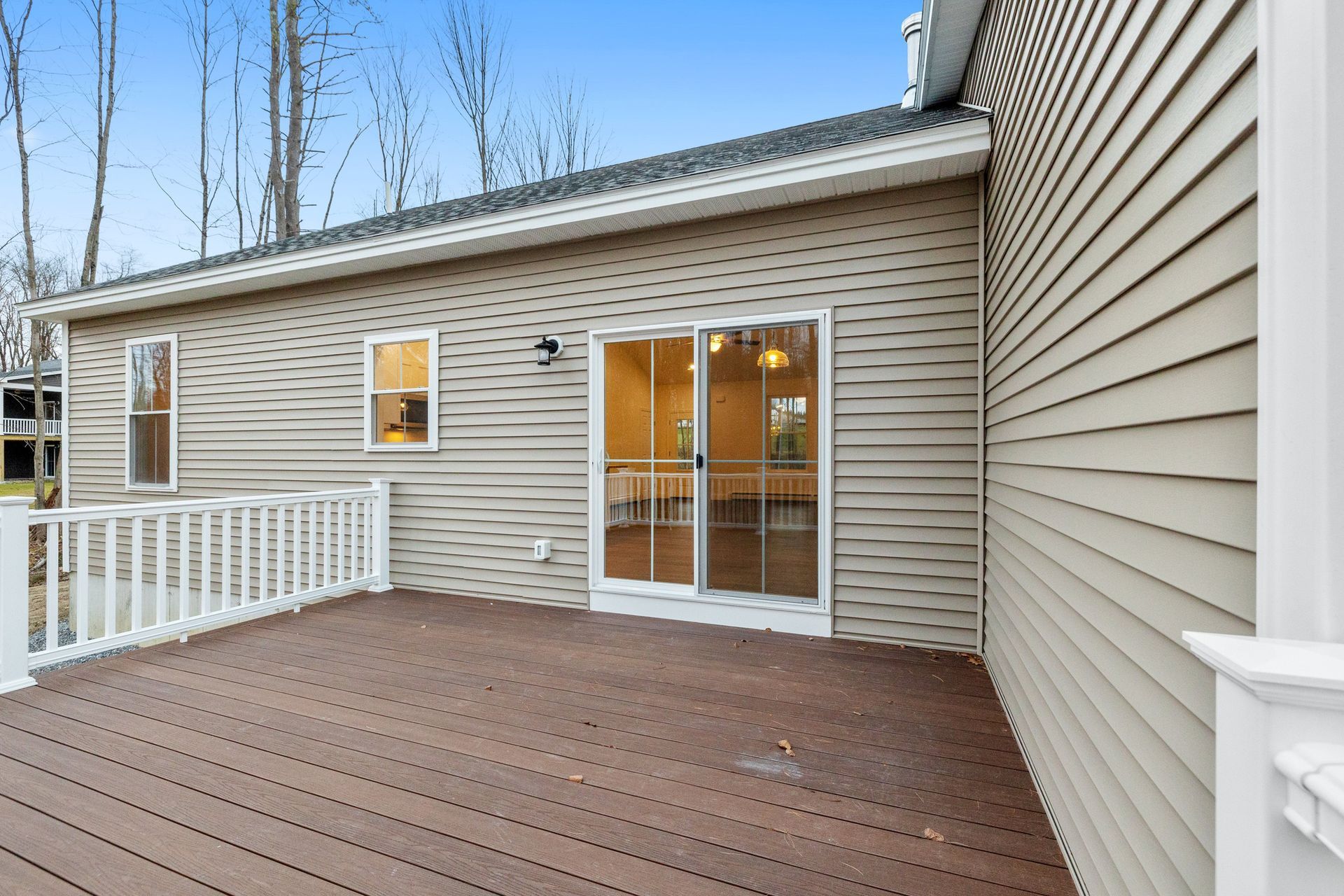A house with a deck and sliding glass doors