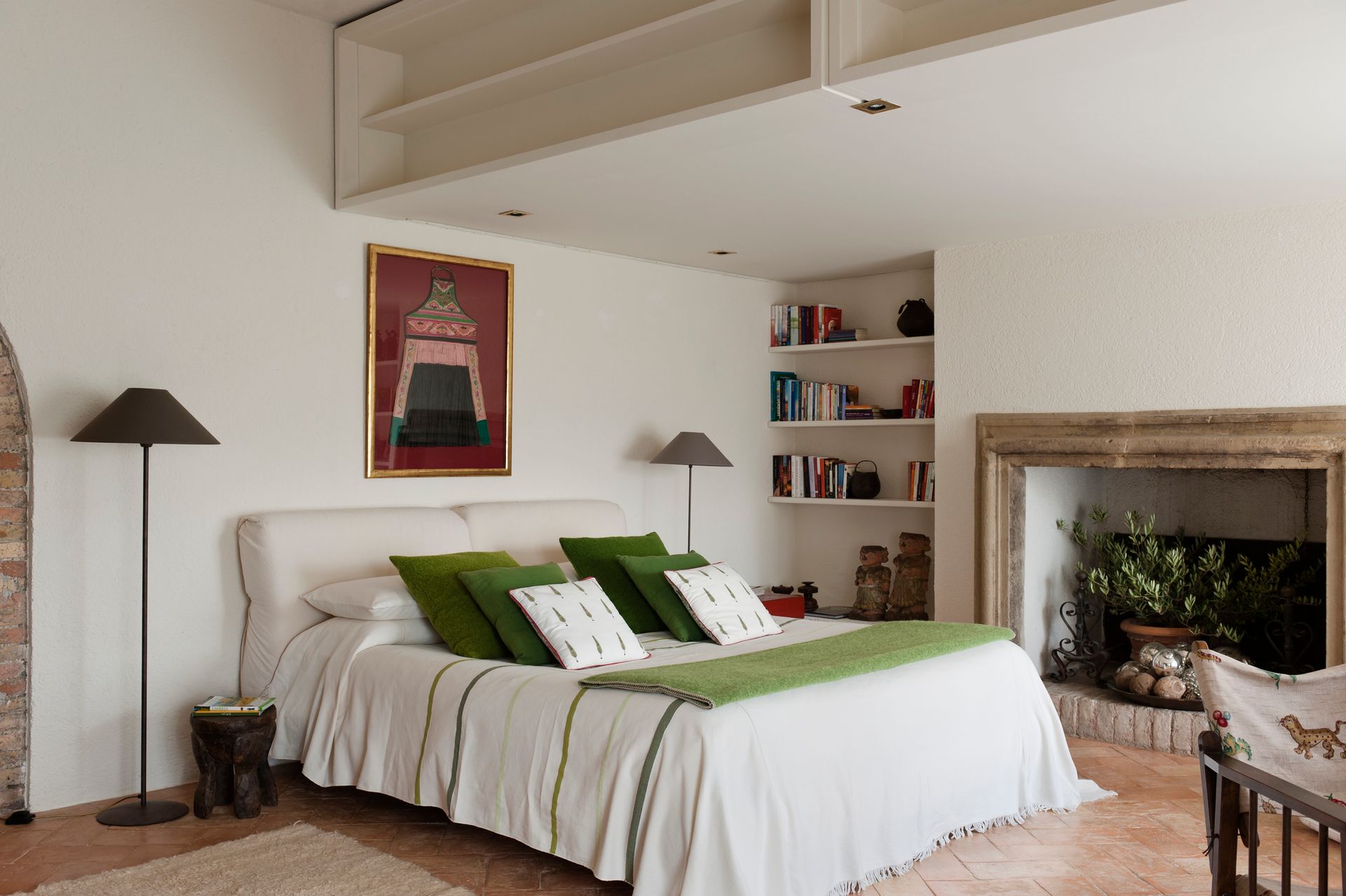 A bedroom with a large bed and a fireplace. A bedroom with a large bed and a fireplace.