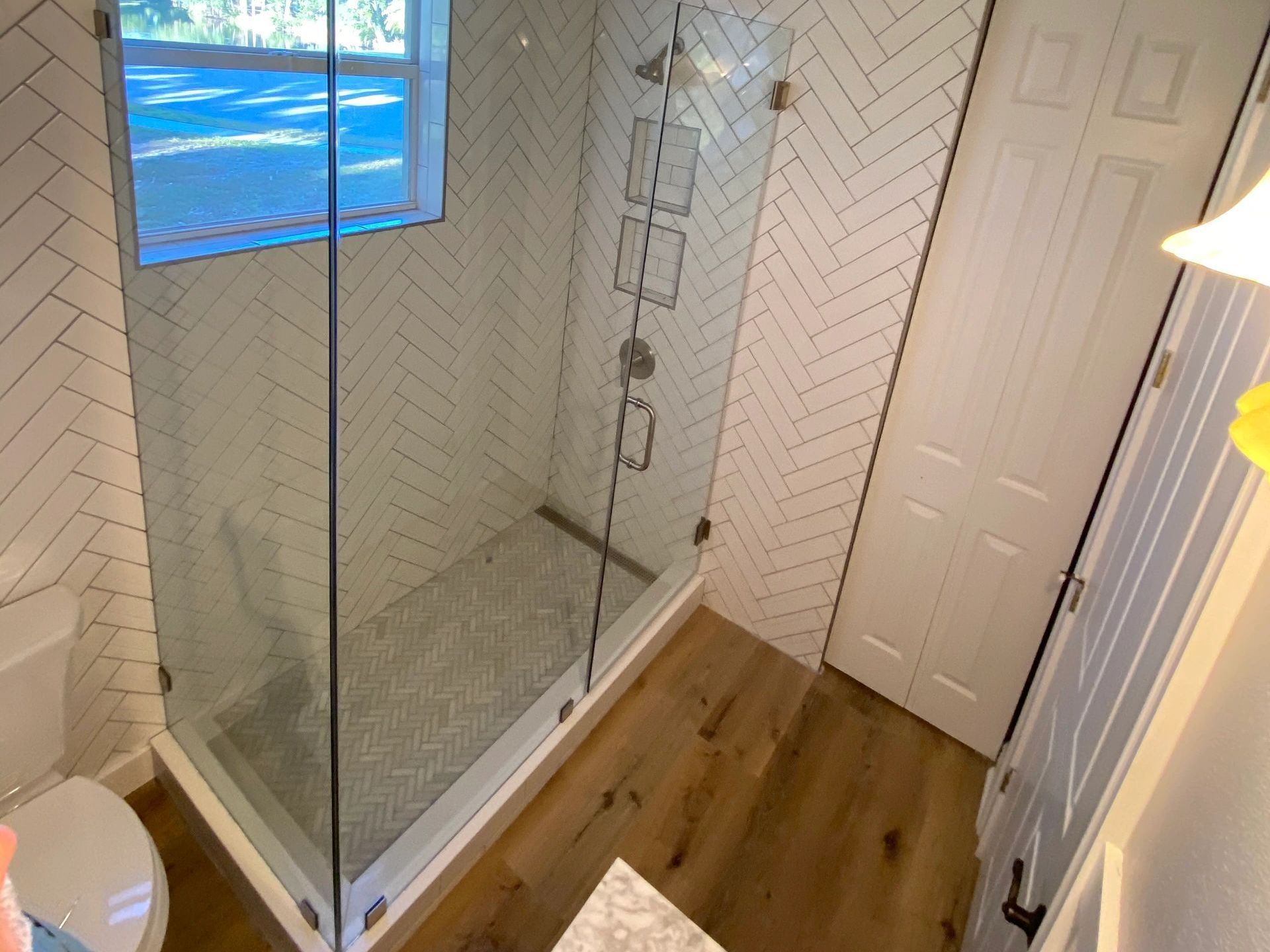 A bathroom with a walk in shower and a toilet. A bathroom with a walk in shower and a toilet.
