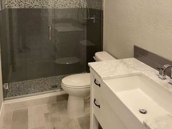 A bathroom with a toilet , sink and shower. A bathroom with a toilet , sink and shower.