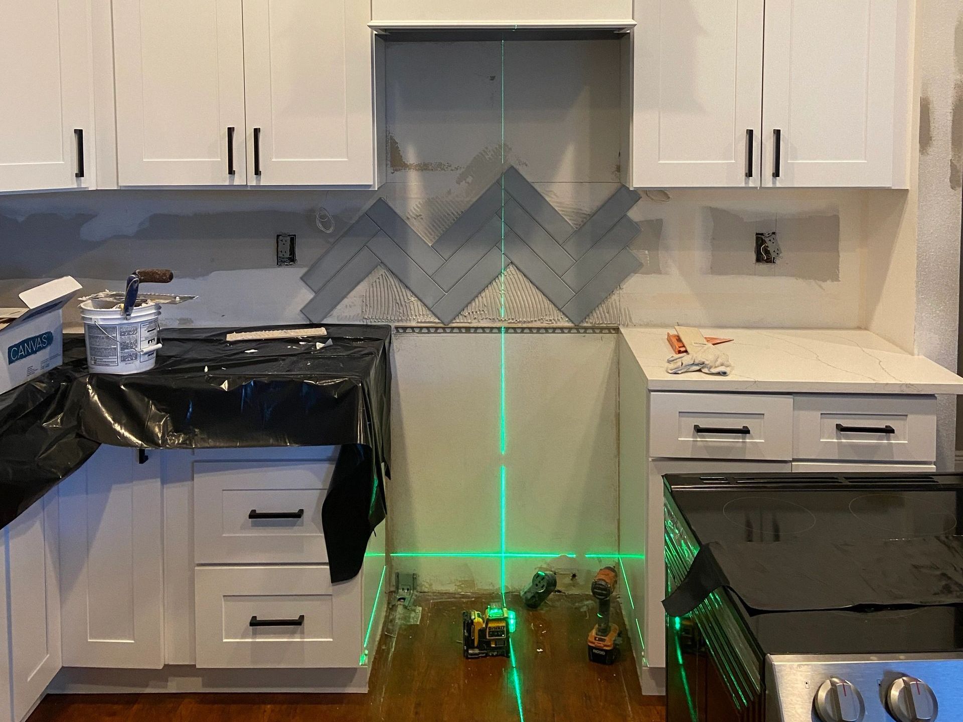 A kitchen under construction with a green laser beam. A kitchen under construction with a green laser beam.