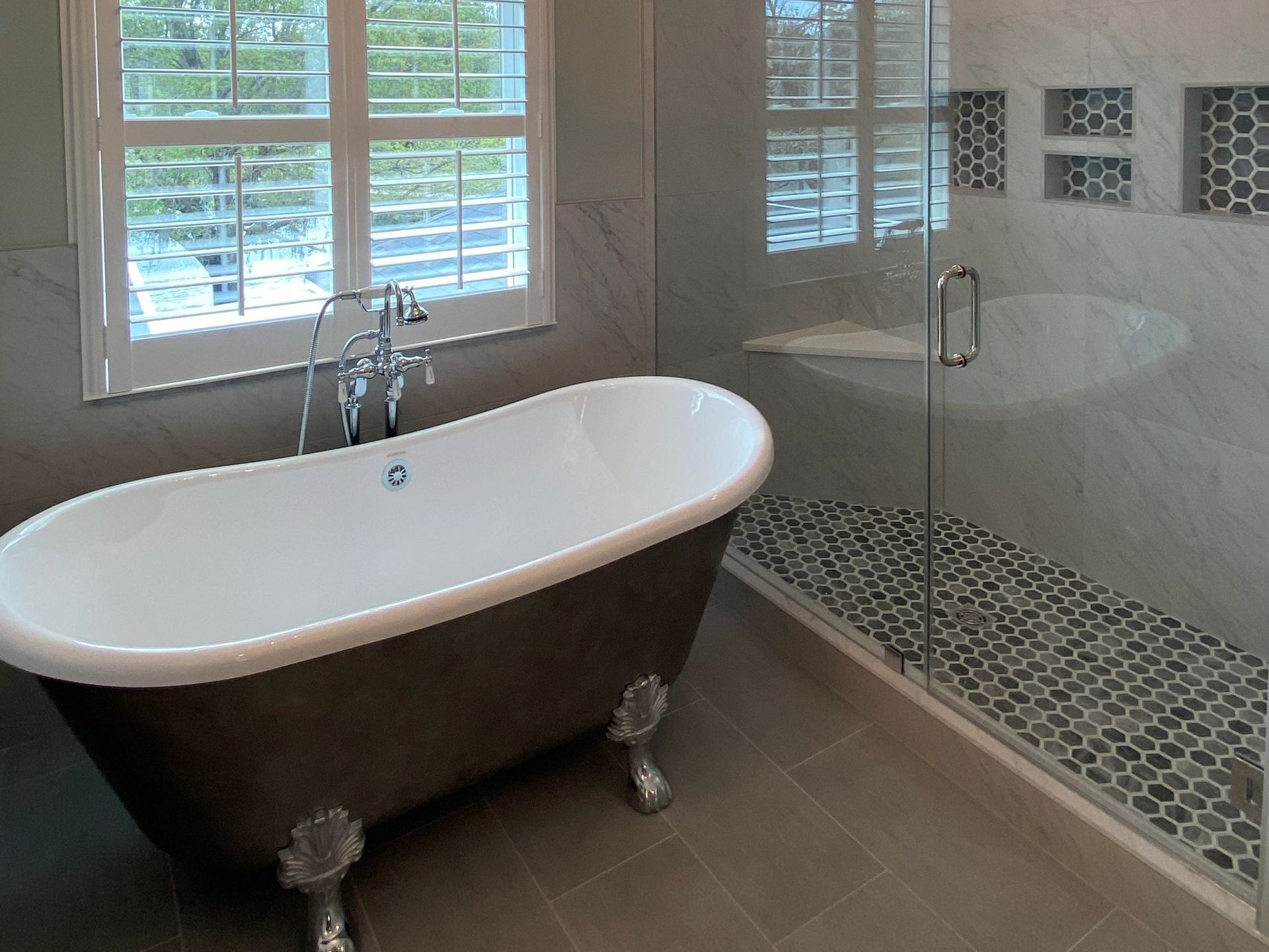 A bathroom with a bathtub and a walk in shower A bathroom with a bathtub and a walk in shower