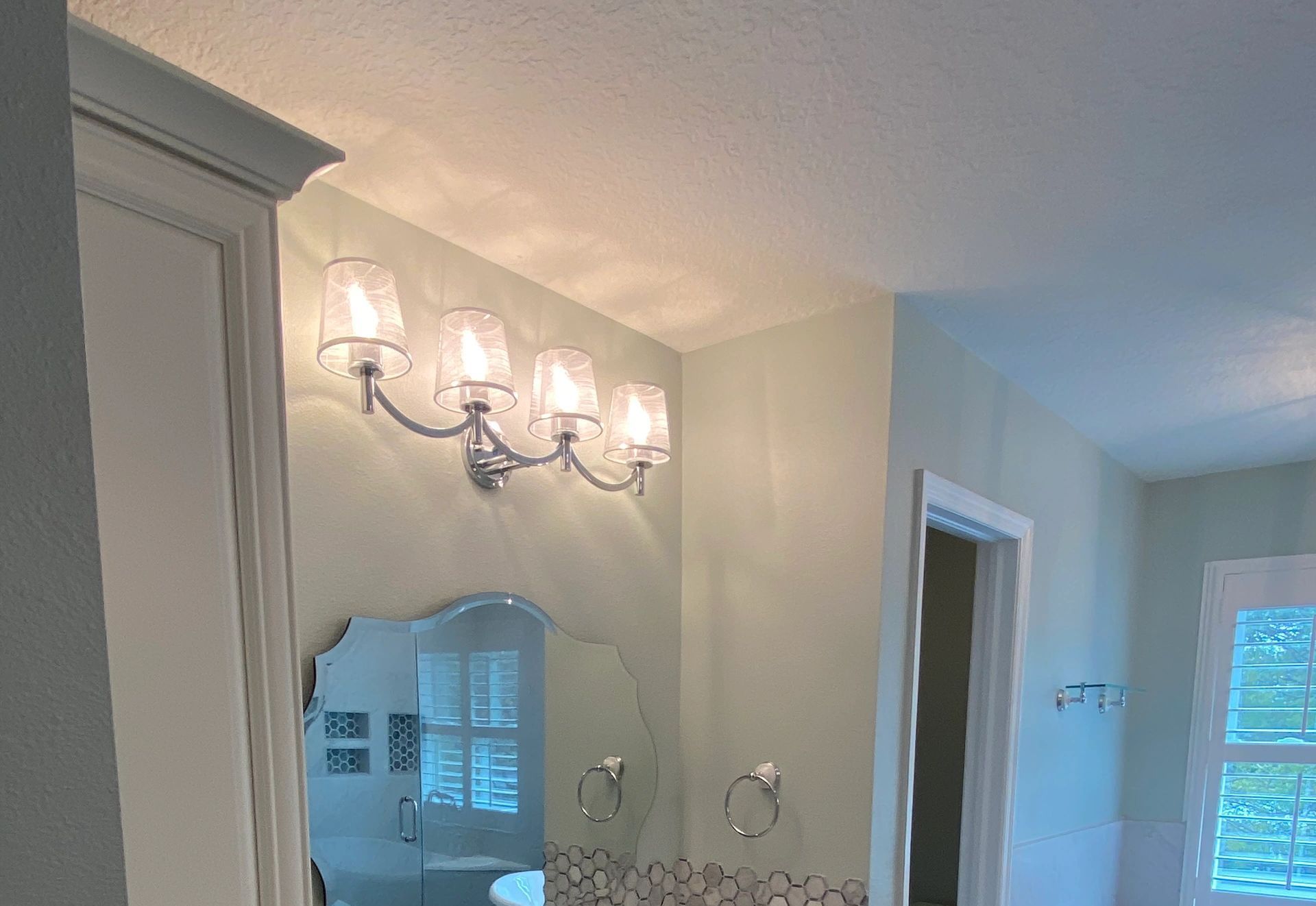 A bathroom with a sink , mirror , and light fixtures. A bathroom with a sink , mirror , and light fixtures.