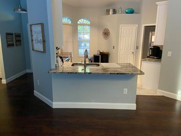 A kitchen with a granite counter top and a sink. A kitchen with a granite counter top and a sink.