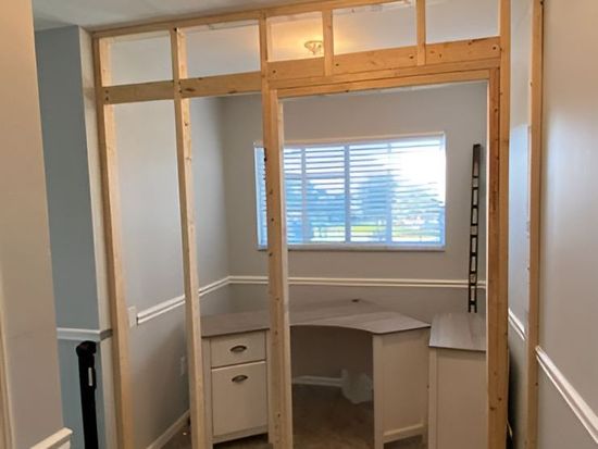 A room with a desk and a window is being built. A room with a desk and a window is being built.