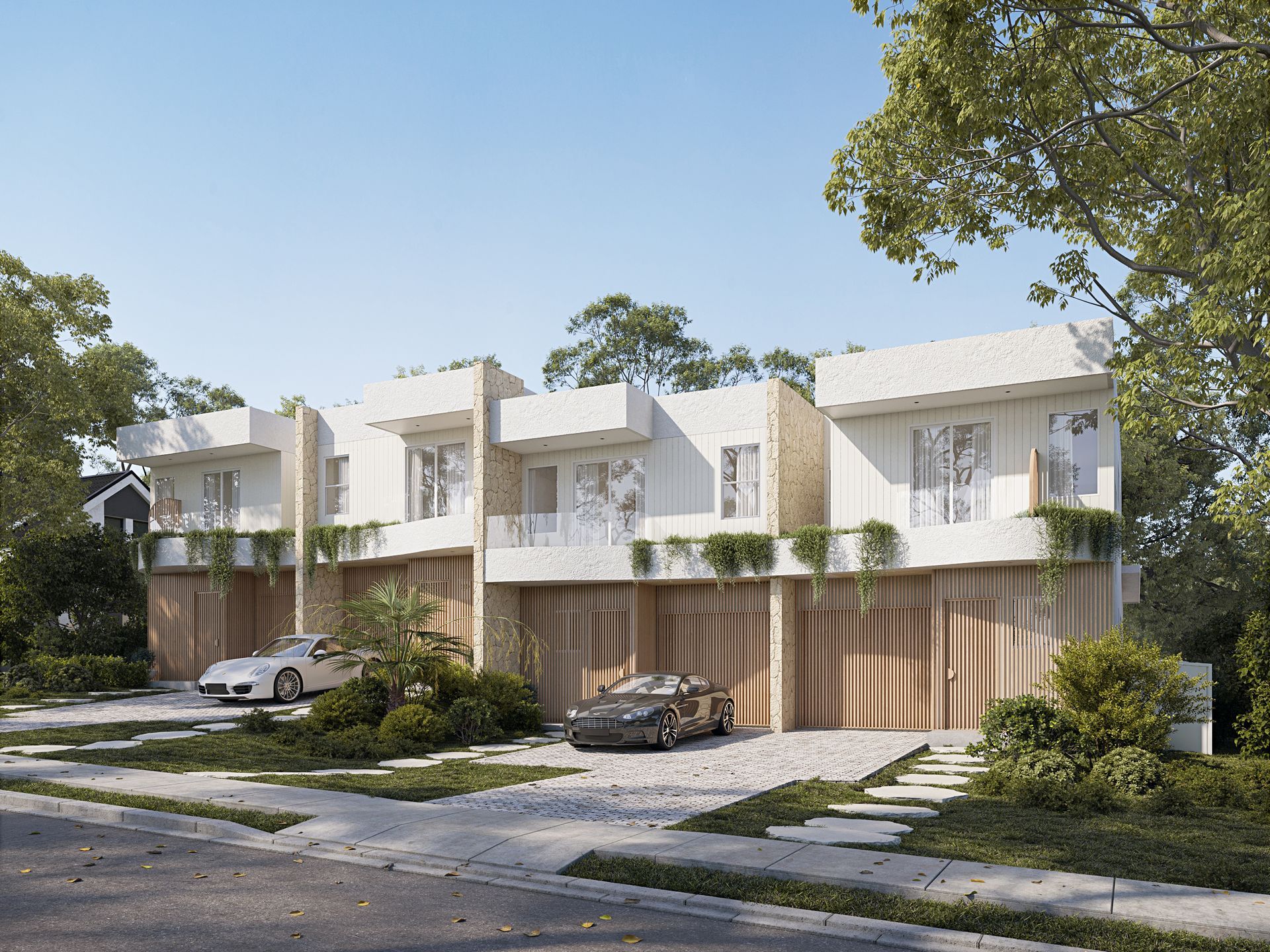 Modern white townhouses with light wood garage doors, cars parked in front — Gracia Building Design In Kiama, NSW