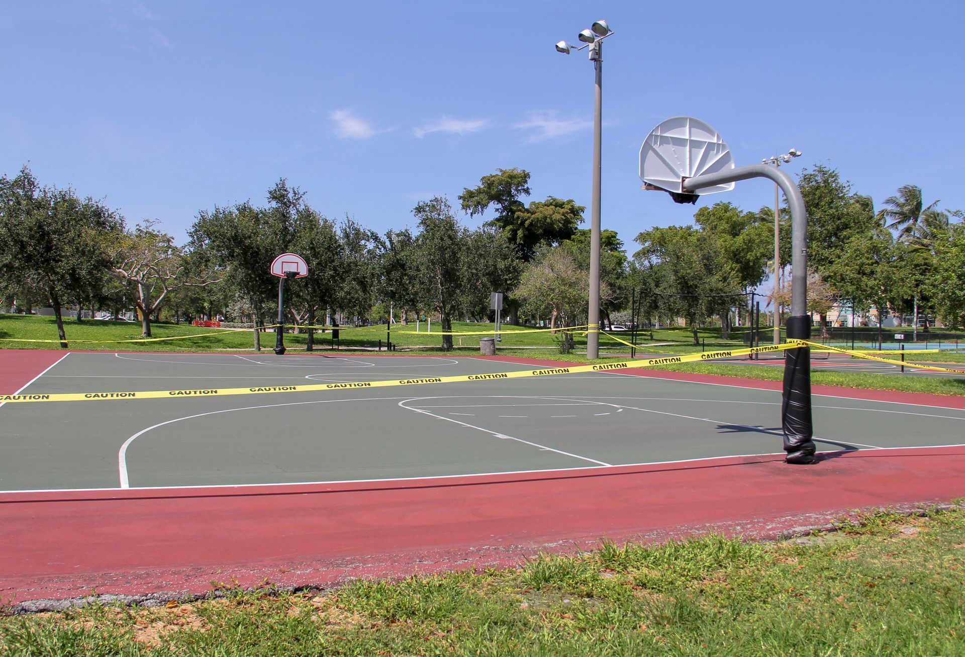 Caution tape around outdoor basketball court — Pine State Asphalt — Windham, ME