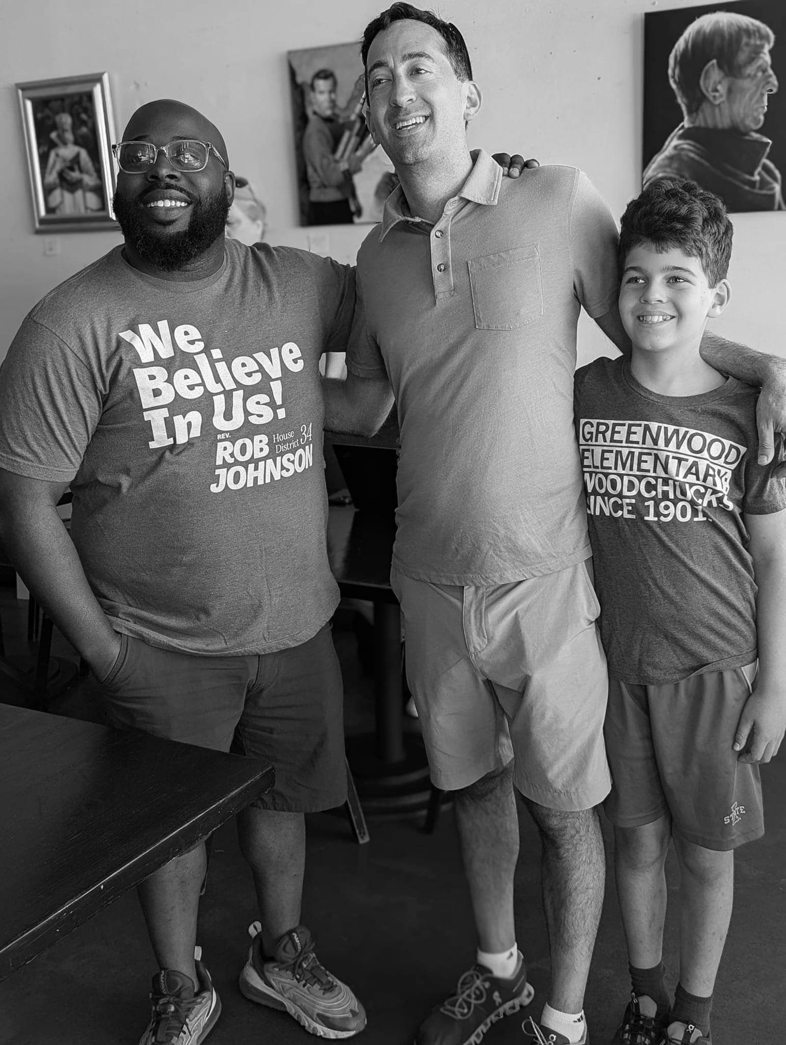 Rep. Rob Johnson, City Councilor Josh Mandelbaum, and a child pose at the beginning of a local canvassing event.