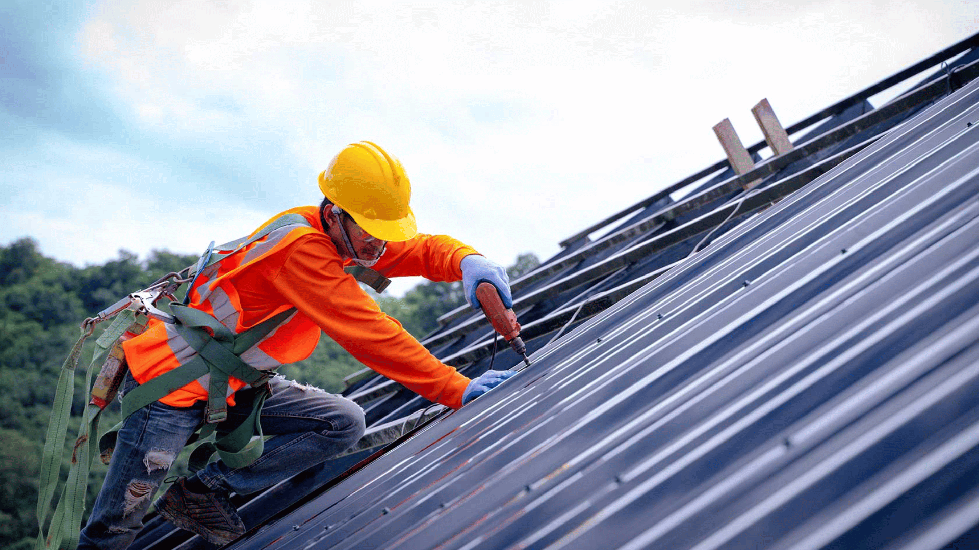 A construction worker is working on the roof of a building.