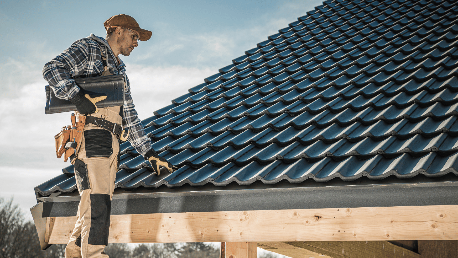 A man is standing on top of a tiled roof.