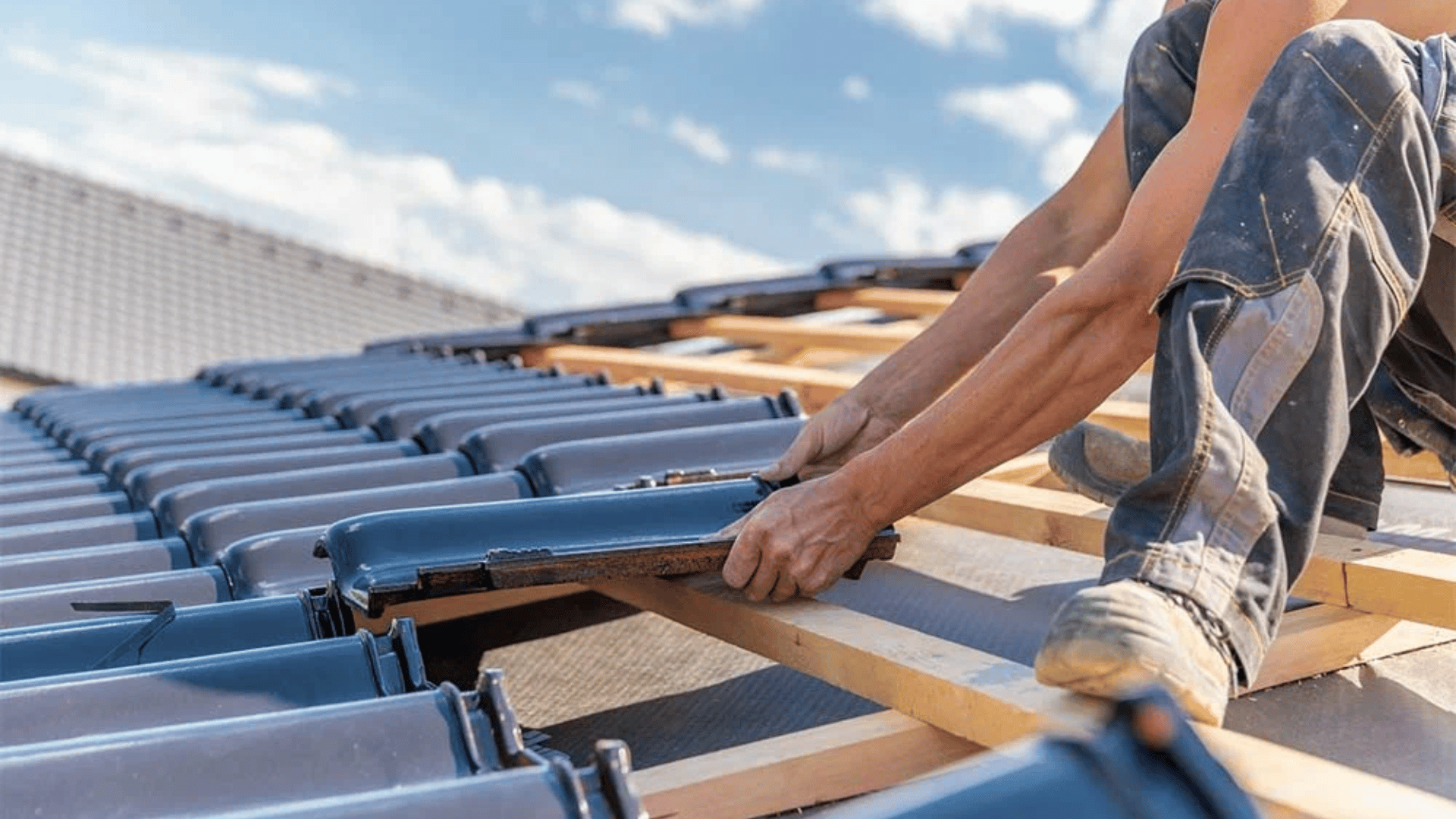 A man is working on the roof of a building.
