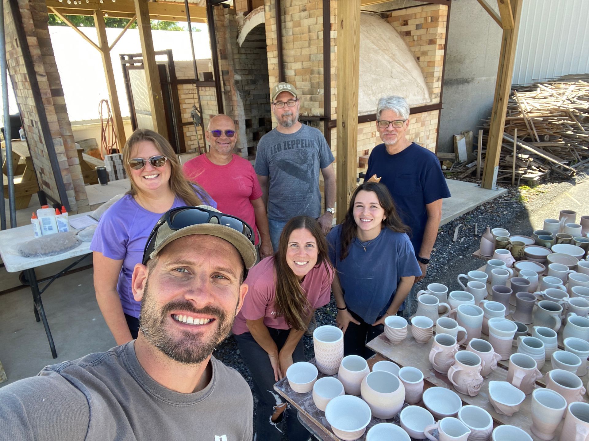 Potters posing at a pottery studio in Lancaster County before firing in a kiln