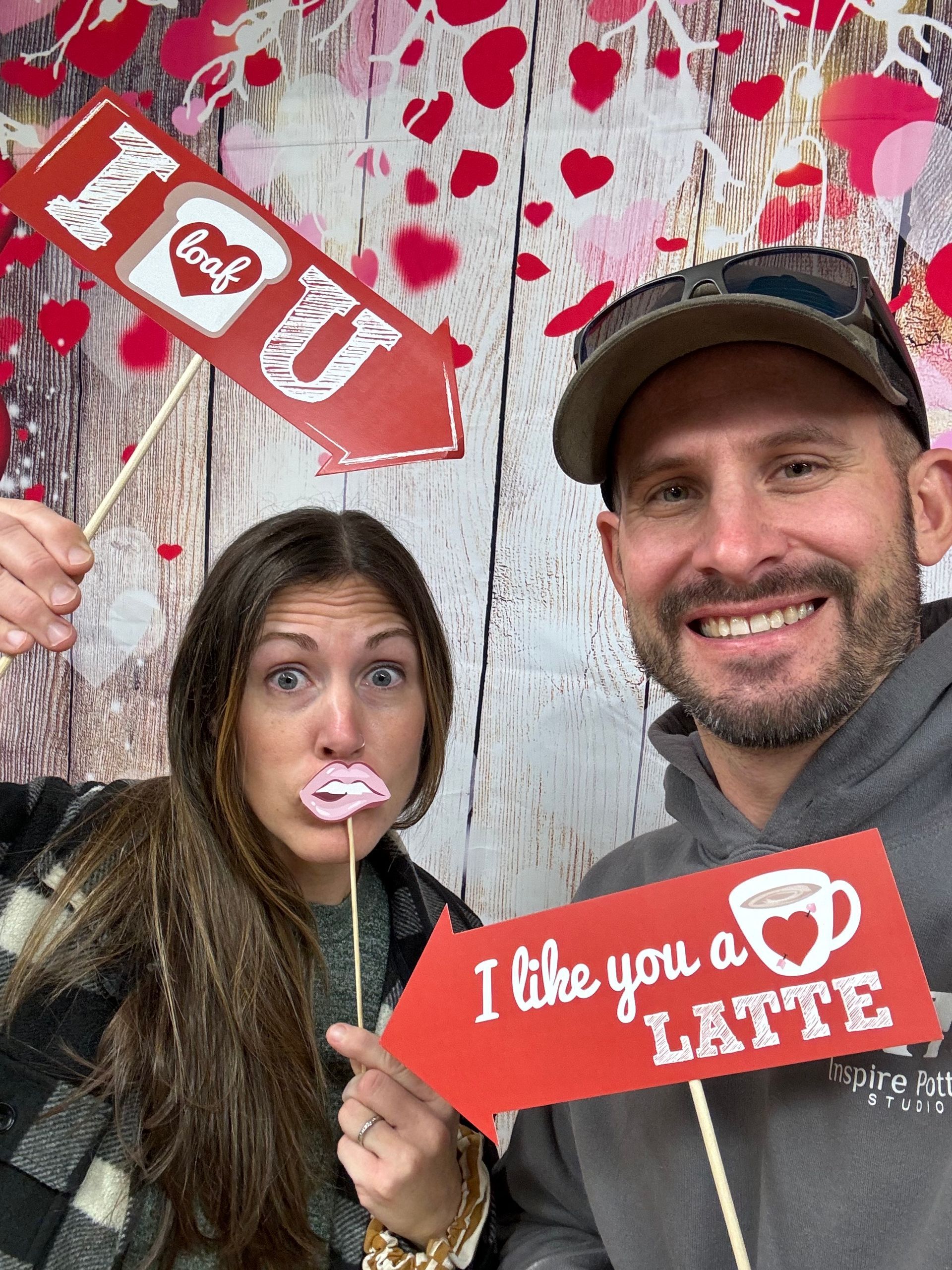 A man and a woman are holding a sign that says i like you a latte.