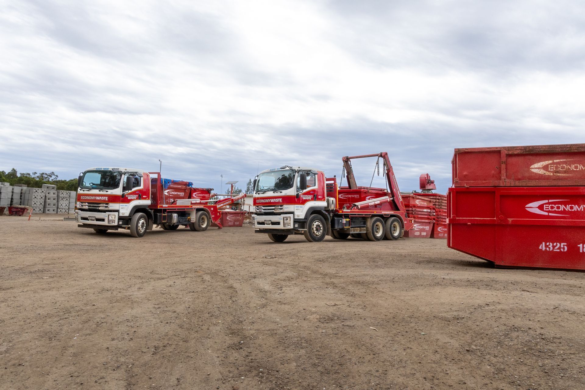Three Red and White Work Trucks Parked — Economy Waste Group | Skip Bins Central Coast In Lake Haven, NSW