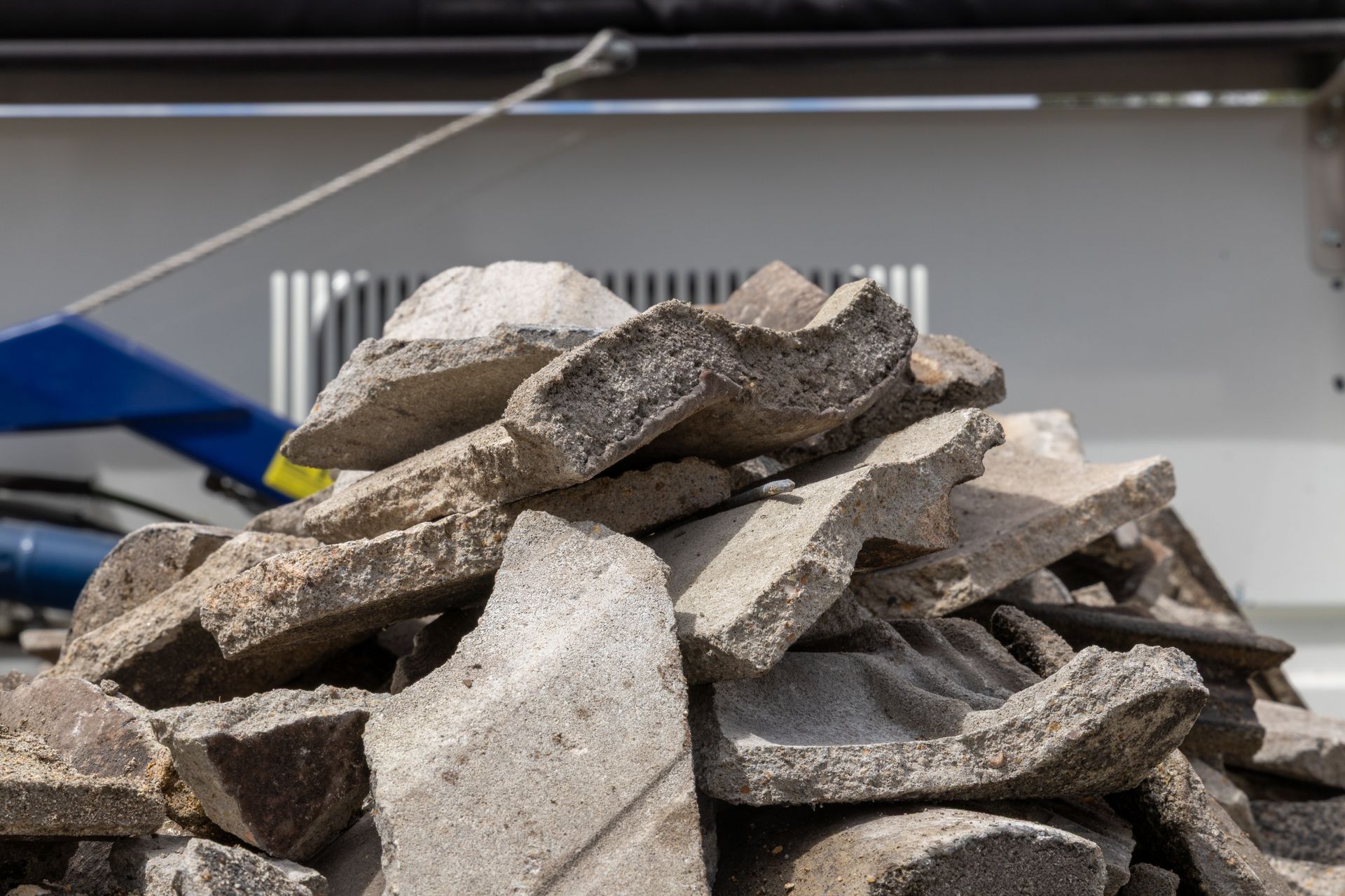 A Baled Cardboard Stacked on Wooden Pallets — Economy Waste Group | Skip Bins Central Coast In West Gosford, NSW
