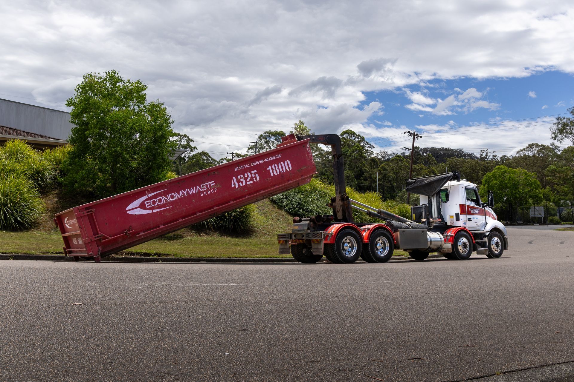 A Red Economy Waste Group Dumpster — Economy Waste Group | Skip Bins Central Coast In West Gosford, NSW