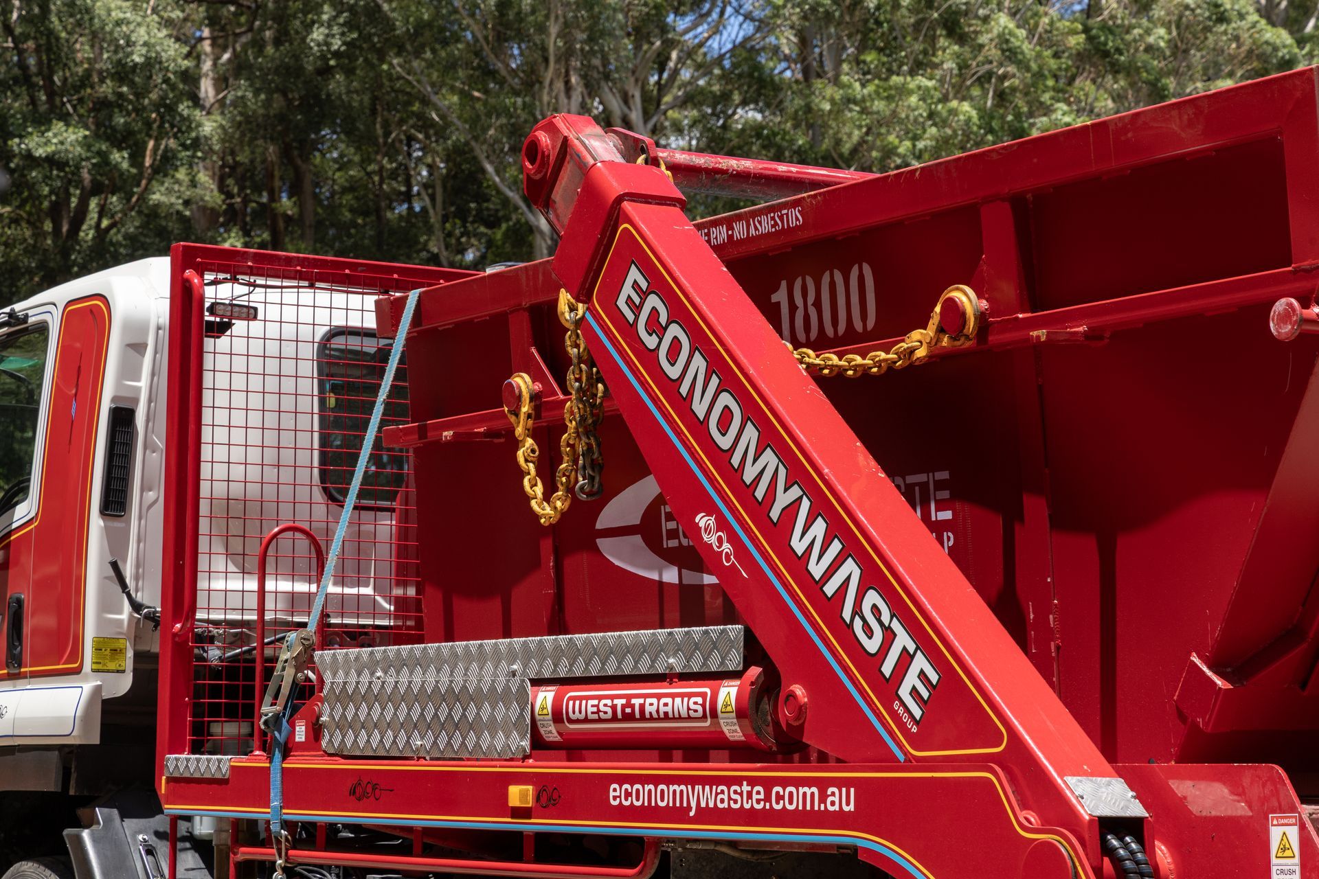 A Red Economy Waste Dumpsters Stacked Outside — Economy Waste Group | Skip Bins Central Coast In West Gosford, NSW