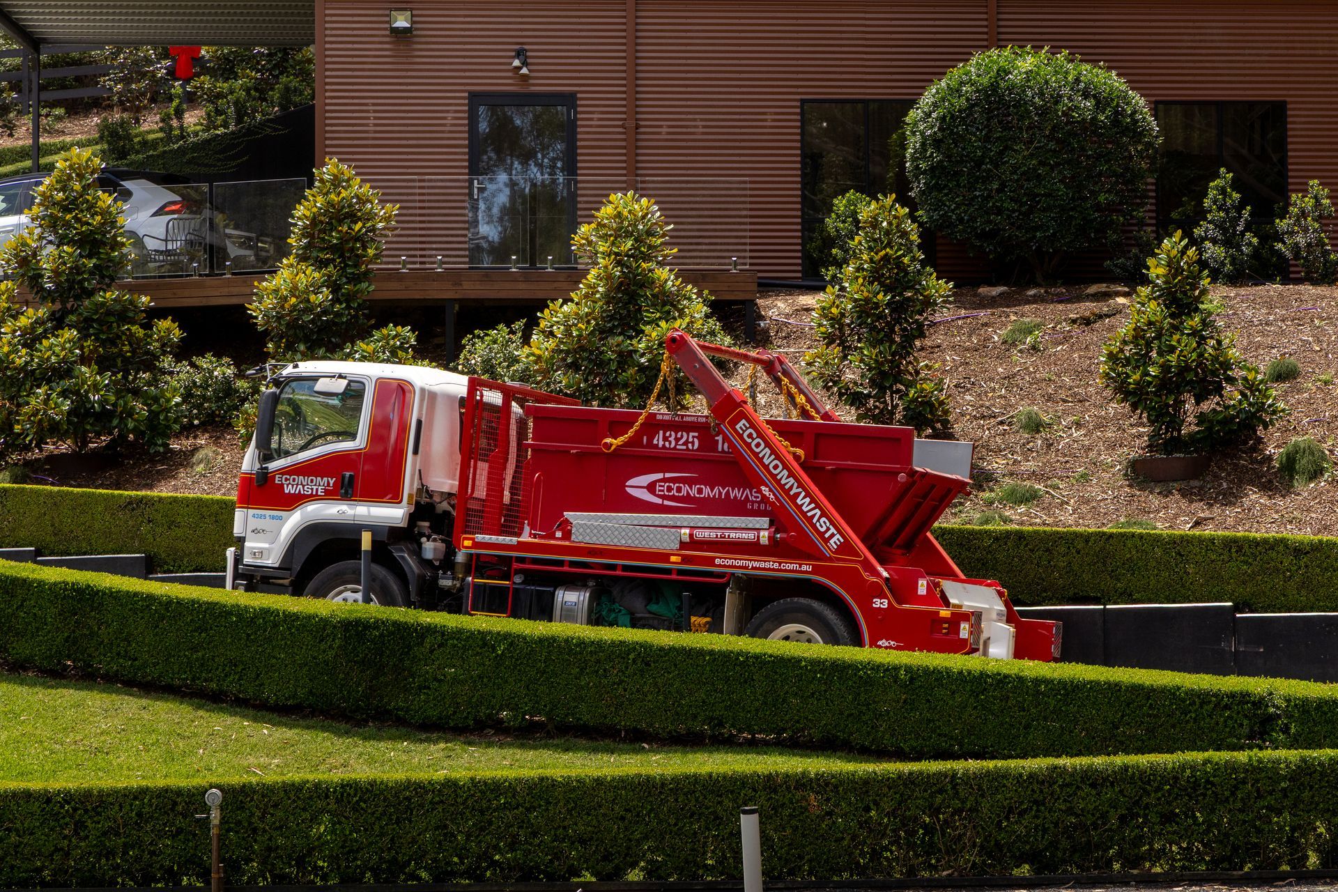 A Red Economy Waste Truck — Economy Waste Group | Skip Bins Central Coast In West Gosford, NSW