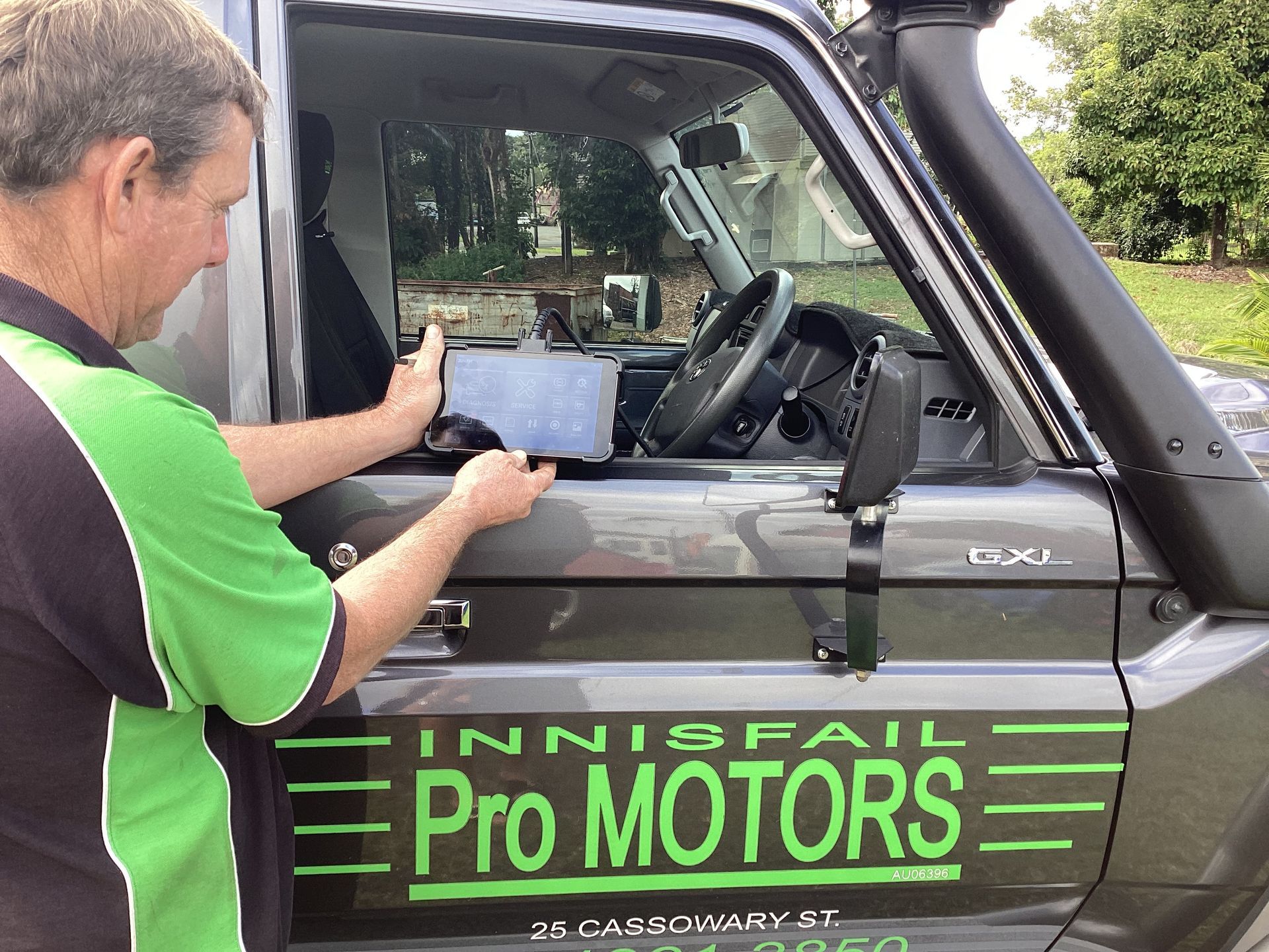 Man Holding Latest Scan Tool — Innisfail Pro Motors In Innisfail, QLD