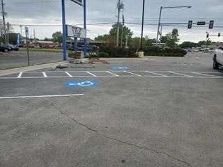 Parking lot with a handicapped parking symbol in blue.