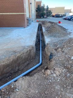 Interior of a building under construction, showing a freshly poured concrete floor.
