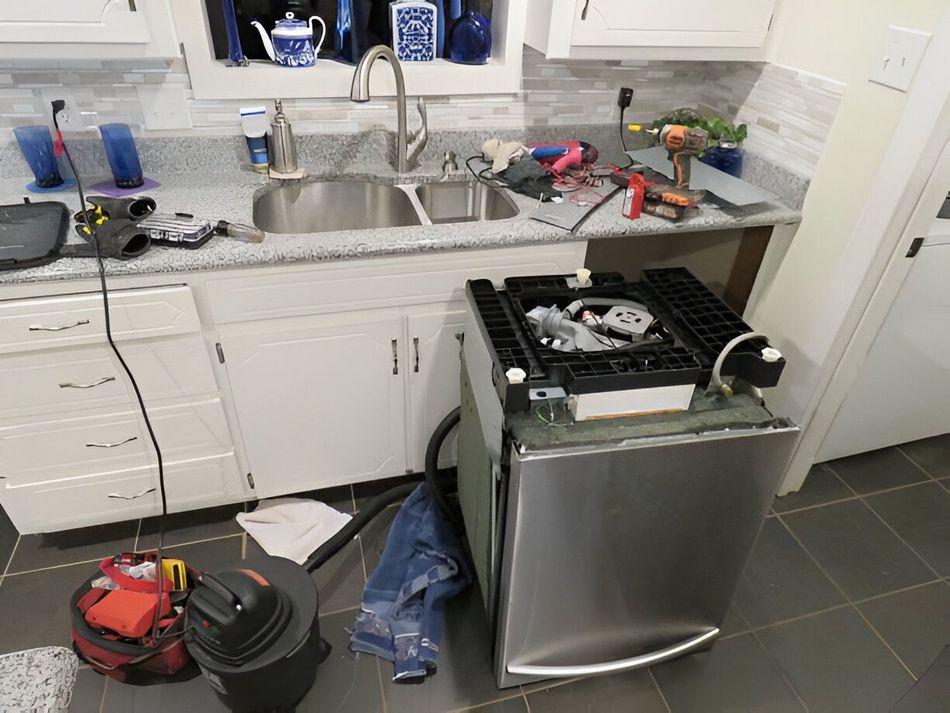 A kitchen with a stove top oven and a sink