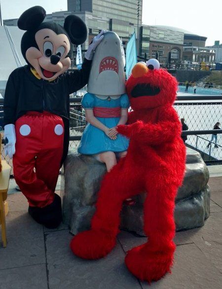 Costumed character lookalikes Mickey mouse and Elmo